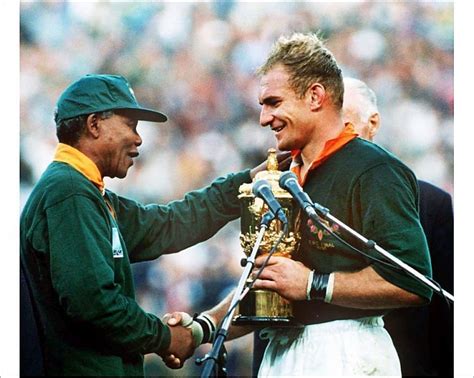 Print of South Africa captain Francois Pienaar receives the World Cup from Nelson Mandela in ...