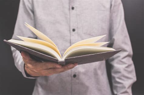 Hand holding a book 1902048 Stock Photo at Vecteezy