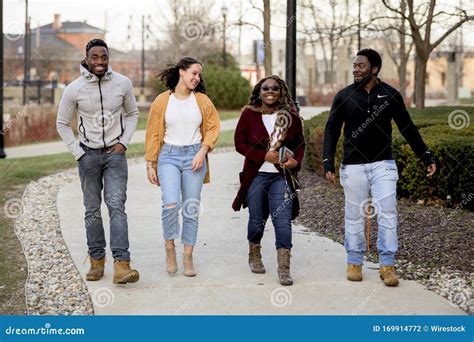 Group of Friends Walking Happily on the Sidewalk in a Park Stock Photo - Image of park ...