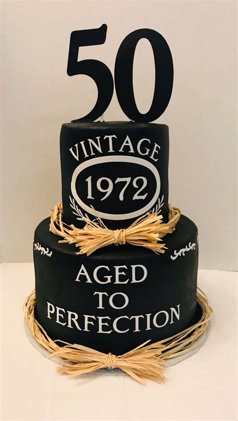 a 50th birthday cake with an aged to perfection sign on the top and 50 year old age