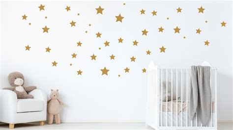 Premium AI Image | White wall with golden stars stickers in baby room interior