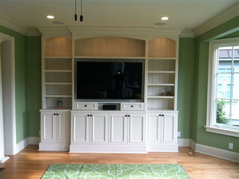 This custom-built entertainment center has plenty of storage space and is complete with detailed ...