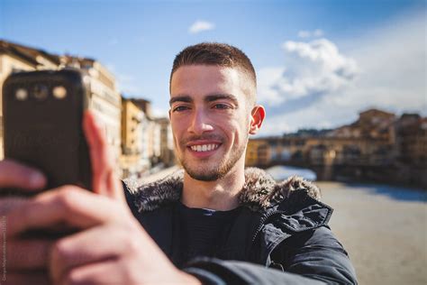 "Young Man Taking A Selfie With A Mobile Phone In Florence" by Stocksy Contributor "Giorgio ...