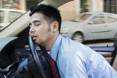 Tired young man sleeping inside the car — Stock Photo © realinemedia #77709496