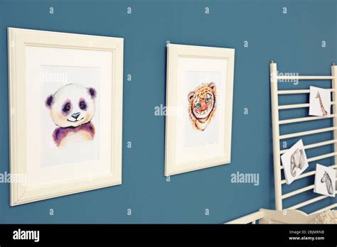 Pictures of animals on wall in baby room Stock Photo - Alamy