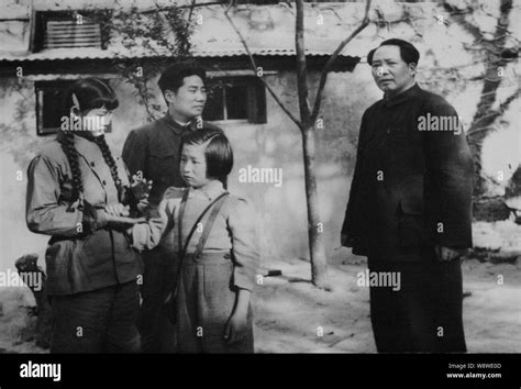 In this file photo, Mao Zedong stands next to Mao Anying, second left, the eldest son of Mao ...