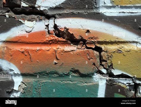 Graffiti on a cracked brick wall Stock Photo - Alamy