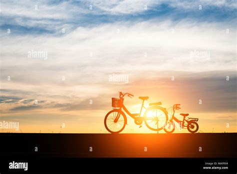 Two Silhouette vintage bicycle at sunset Stock Photo - Alamy