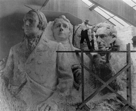 The sculptor of Mount Rushmore, Gutzon Borglum, with a model of the four presidents that ...