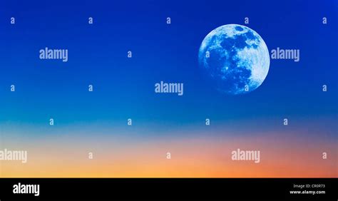 Full moon on evening sky Stock Photo - Alamy