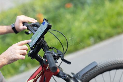 Man Planning Route Using GPS Navigation Application in Mobile Phone on His Bicycle Bike. Stock ...