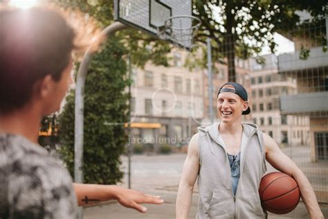 Happy young streetball players on court. – Jacob Lund Photography Store- premium stock photo