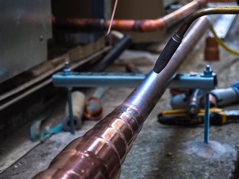 Premium Photo | Brazing copper pipes with a gas torch