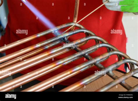 Worker working on brazing copper - close-up Stock Photo - Alamy