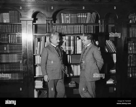 The physicist and Nobel Prize winner (1921) Albert Einstein stands in front of bookshelves with ...