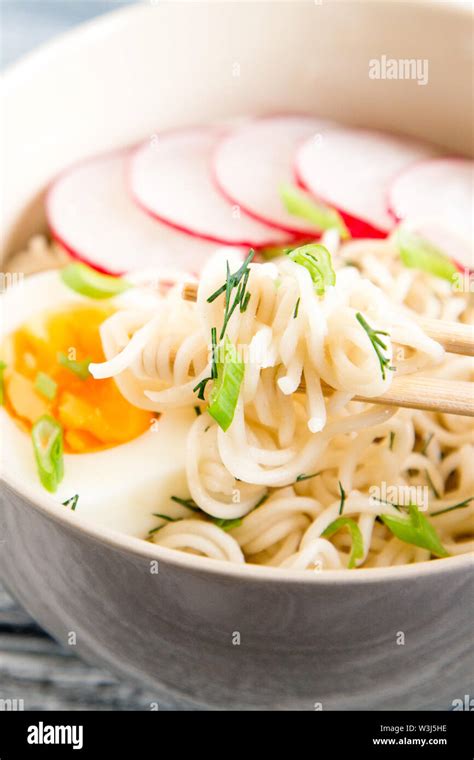 Instant noodles on wooden background. Cooked chinese instant noodles. Soup Ramen with egg and ...