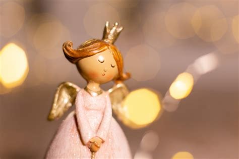 Premium Photo | Decorative christmas-themed figurines. statuette of a christmas angel