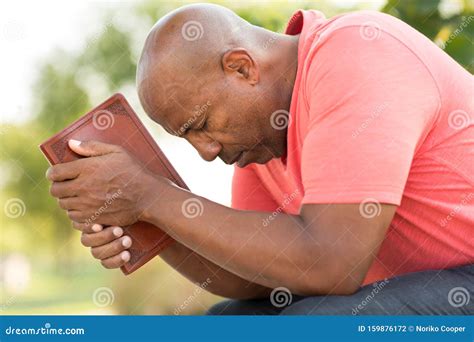 African American Man Holding Bible Stock Photos by Megapixl