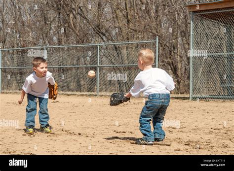 Two boys play catch throwing ball Stock Photo - Alamy