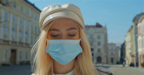 Beautiful blond Girl Wearing Medical Mask During Coronavirus COVID-19 Epidemic Pandemic Covid-19 ...