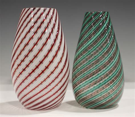 Two Murano glass vases, mid-20th century, the first with spirals of amethyst and green mezza filigra