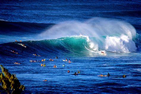 Surfing At Sunset Beach Stock Photo - Download Image Now - iStock