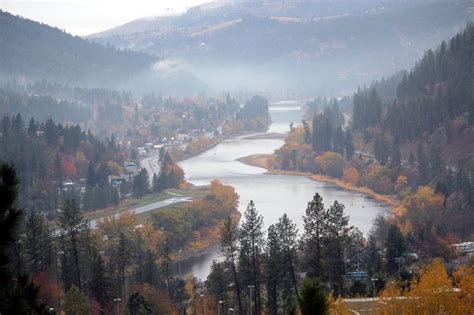 a lake surrounded by trees in the mountains