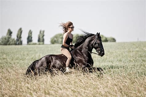 "People: Woman Riding A Black Horse In A Agrass Meadow" by Stocksy Contributor "Ina Peters ...