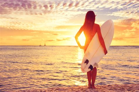 Surfer girl surfing looking at ocean beach sunset – Waterton Publishing Company