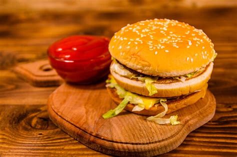 Premium Photo | Hamburger and sauce on a wooden table