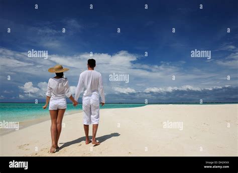 Couple on a beach at Maldives Stock Photo - Alamy