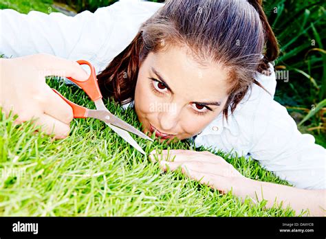 Woman cutting grass with scissors Stock Photo - Alamy