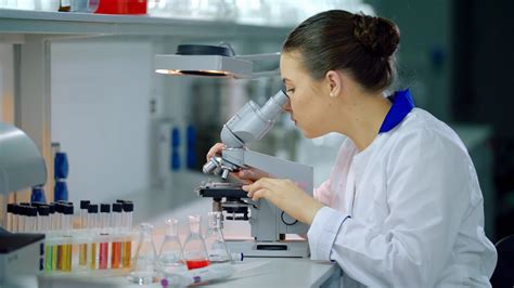 Female Scientist With Microscope In Lab Stock Footage SBV-313175956 - Storyblocks