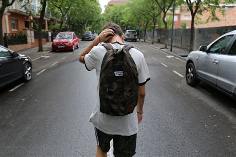 teen boy walking home from school wearing a backpack, not a known avenue 4k HD Wallpaper