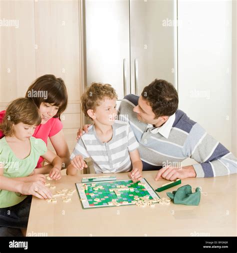 family playing scrabble Stock Photo - Alamy