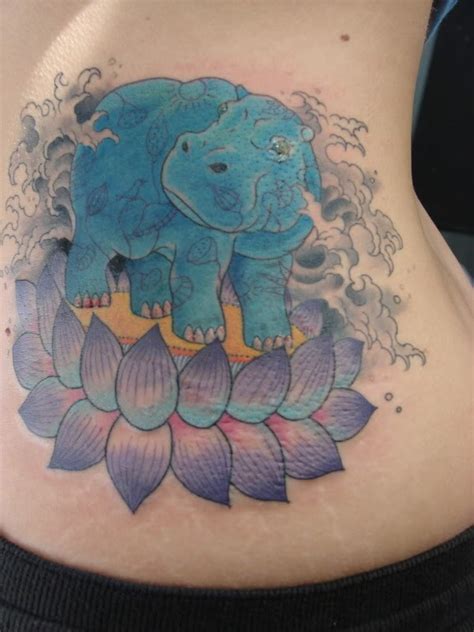 Awesome blue hippo and violet lotus flower tattoo on rib-side - Tattooimages.biz