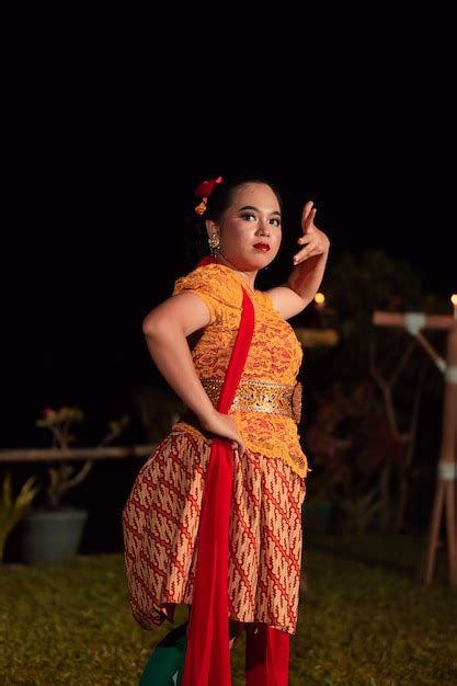 Premium Photo | Balinese dancers in yellow color traditional costumes present the dance in front ...