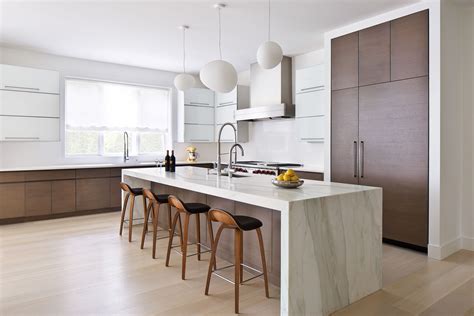 Modern kitchen with waterfall island countertop | Modern kitchen island, Marble kitchen island ...