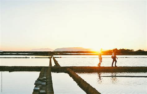 "Young Friends Walking At Sunset" by Stocksy Contributor "Giulia Squillace" - Stocksy