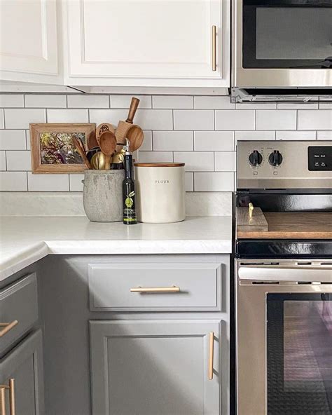 Stainless Steel Stove Pushed Against White Subway Tile Backsplash - Soul & Lane