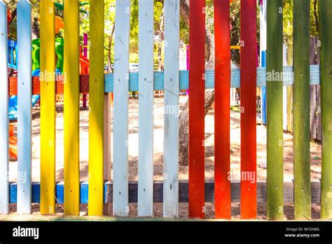 Fencing of various bright colors. The fence stands around the playground Stock Photo - Alamy