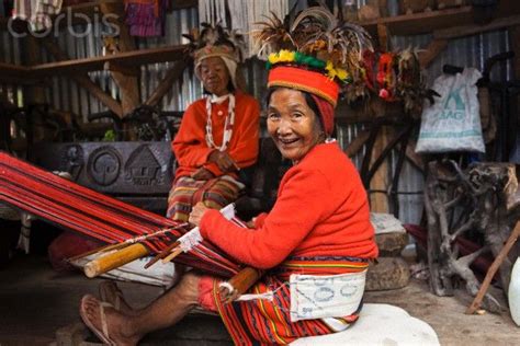 Ifugao woman in traditional clothing weaving textiles on a hand loom ...