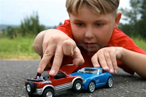 A boy playing with toy cars | Stock image | Colourbox