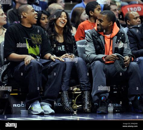 Entertainers Jay-Z, left, Beyonce and Kanye West, right, laugh during the New Jersey Nets' NBA ...