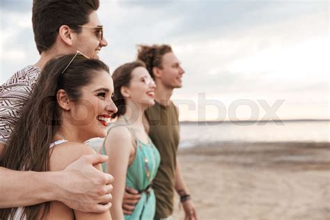 Group of a cheerful young friends walking at the beach | Stock image | Colourbox