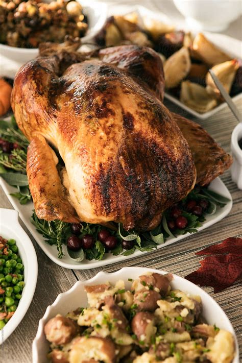 "Thanksgiving: Roast Turkey On Table With Side Dishes" by Stocksy Contributor "Sean Locke" - Stocksy