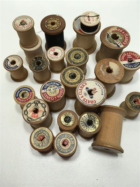 several spools of thread are arranged on a white surface with other spools