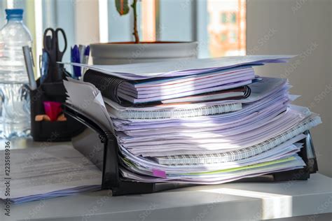 Pile of papers in the office tray. Concept of office clutter and lean production. Stock Photo ...