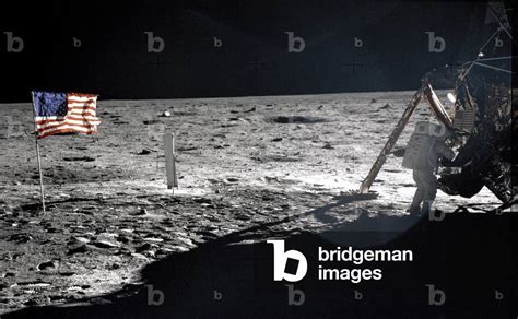 Image of NEIL ARMSTRONG, standing on the moon, near the flag, July