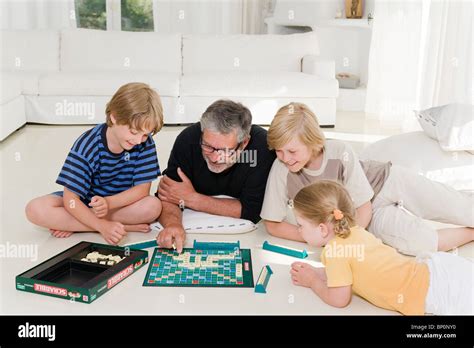 Family playing scrabble Stock Photo - Alamy